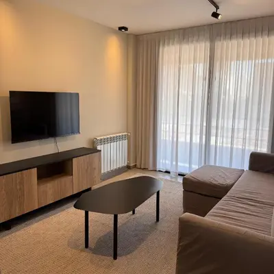 a living room with a couch and a flat screen tv at Faz Flat in Cordoba