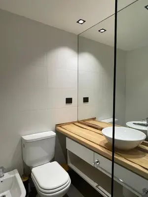 a bathroom with a white toilet and a sink at Faz Flat in Cordoba
