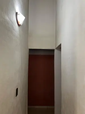 a hallway with a door and a light on the wall at Cabaña Don Licho in San Javier