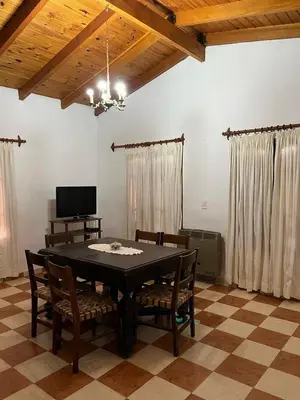 a dining room with a black table and chairs at Cabaña Don Licho in San Javier