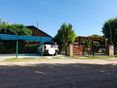 a truck parked in front of a building at Cabañassoleado Villa Cura Brochero in Villa Cura Brochero