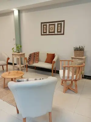 a living room with chairs and a couch and tables at Brit Hotel in Villa Carlos Paz
