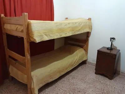 a bunk bed in a room with a side table at La Morada de sus Sueños in Bialet Massé