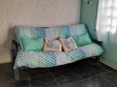 a couch with pillows on it in a room at La Morada de sus Sueños in Bialet Massé