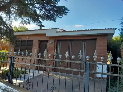 a house with a fence in front of it at La Morada de sus Sueños in Bialet Massé