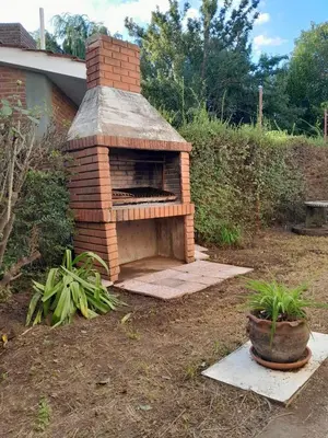 a brick oven in a yard with a potted plant at La Morada de sus Sueños in Bialet Massé