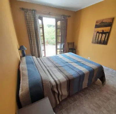 a bedroom with a bed in a room with a window at Departamento céntrico Villa Carlos Paz in Villa Carlos Paz