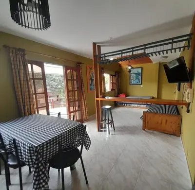 a dining room with a table and a bunk bed at Departamento céntrico Villa Carlos Paz in Villa Carlos Paz