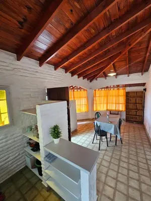 a kitchen and dining room with a table and a refrigerator at Casa Tilo número 1 in Mina Clavero