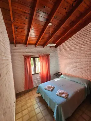 a bedroom with a bed with two towels on it at Casa Tilo número 1 in Mina Clavero