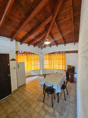 a dining room with a table and chairs in a room at Casa Tilo número 1 in Mina Clavero