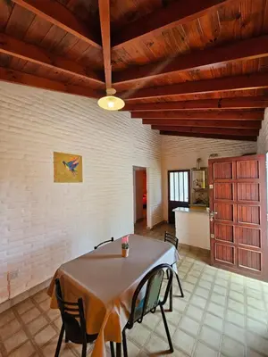 a dining room with a table and chairs at Casa Tilo número 1 in Mina Clavero