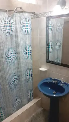 a bathroom with a sink and a shower curtain at Departamento centrico Villa Carlos Paz in Villa Carlos Paz