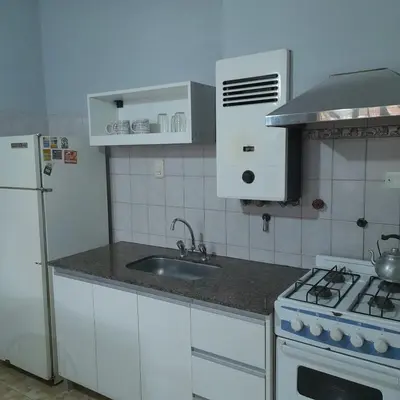a kitchen with a sink and a stove and a refrigerator at Departamento centrico Villa Carlos Paz in Villa Carlos Paz