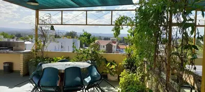 a patio with a table and chairs on a balcony at Departamento centrico Villa Carlos Paz in Villa Carlos Paz