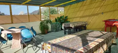 a room with a table and chairs on a patio at Departamento centrico Villa Carlos Paz in Villa Carlos Paz