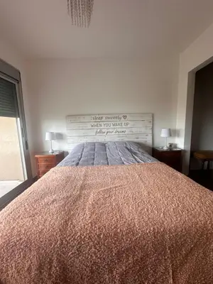 a bedroom with a large bed with a wooden headboard at Departamento Complejo Privado Mai Tei in Cordoba