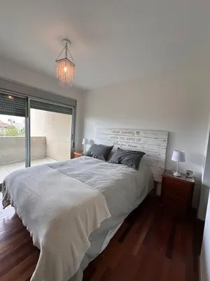 a bedroom with a large bed and a large window at Departamento Complejo Privado Mai Tei in Cordoba