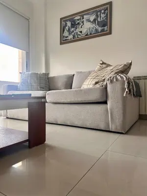 a living room with a couch and a table at Departamento Complejo Privado Mai Tei in Cordoba