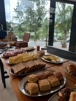 a table with different types of bread and pastries at Hotel Golden Ross in Villa Carlos Paz