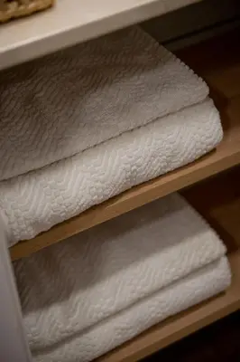 a stack of white towels on a shelf at Moderno loft en Güemes in Cordoba