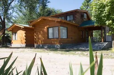 a wooden house on the beach at Del Milagro Cabañas & Posada in Villa General Belgrano