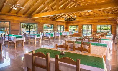 a banquet hall with tables and chairs in it at Del Milagro Cabañas & Posada in Villa General Belgrano