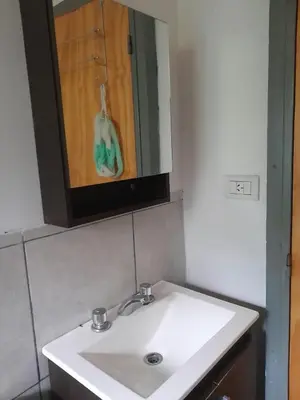 a white sink in a bathroom with a mirror at Luna Azul in Villa Yacanto