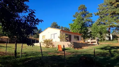 a house in the middle of a yard at Luna Azul in Villa Yacanto
