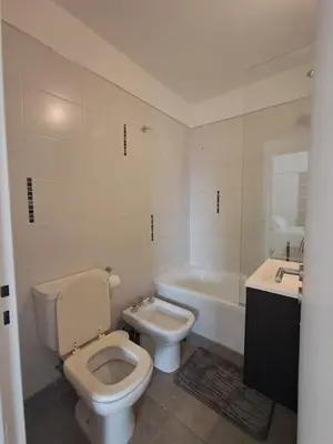 a bathroom with a toilet and a tub and a sink at Figueroa Alcorta B Centro in Cordoba