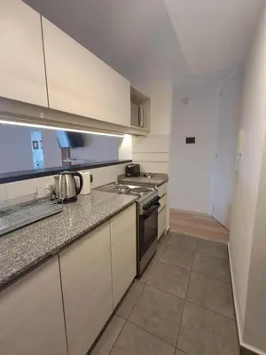 a kitchen with white cabinets and a stove at Figueroa Alcorta B Centro in Cordoba