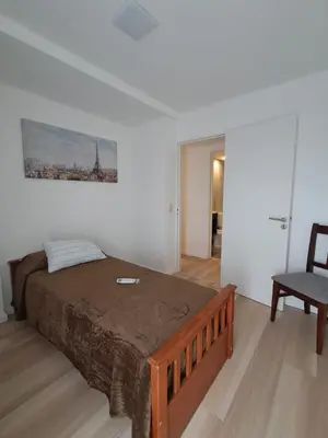 a bedroom with a large bed and a chair at Figueroa Alcorta B Centro in Cordoba