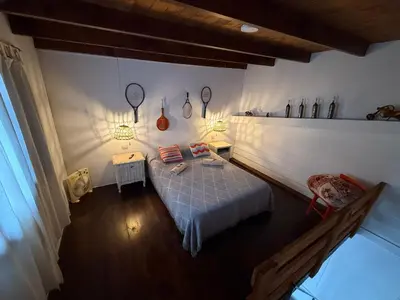 a bedroom with a bed and two lights on the wall at Departamento zona norte in Cordoba