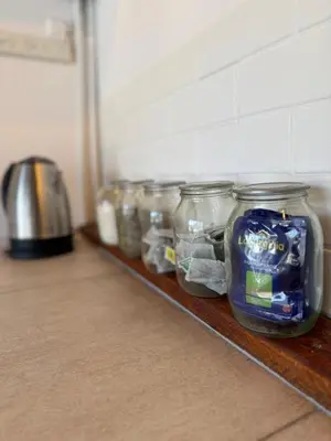 a row of jars on a shelf in a kitchen at Departamento zona norte in Cordoba