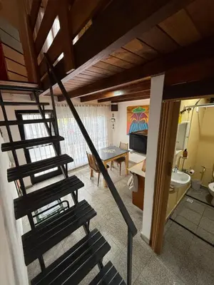 a spiral staircase in a room with a living room at Departamento zona norte in Cordoba