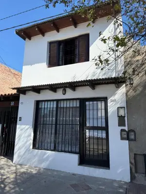 a white house with black windows at Departamento zona norte in Cordoba