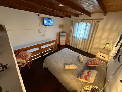 a bedroom with a bed with a television on the wall at Departamento zona norte in Cordoba