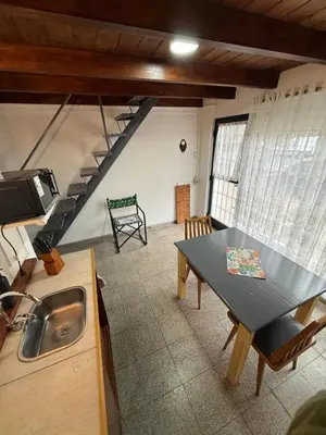 a kitchen with a table and a sink in a room at Departamento zona norte in Cordoba