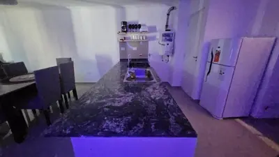a kitchen with a table and a refrigerator at Duplex Luxor Calazans in Cordoba