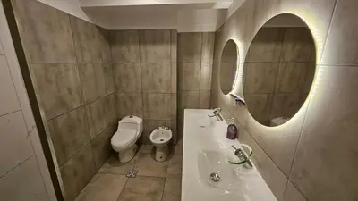 a bathroom with a sink and a toilet and a mirror at Duplex Luxor Calazans in Cordoba