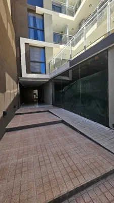 a large building with a walkway in front of it at Duplex Luxor Calazans in Cordoba