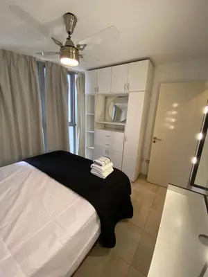 a bedroom with a bed with a black blanket at LitStay Trejo in Cordoba
