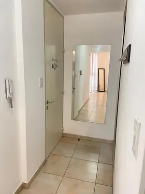 a hallway with a mirror and a tile floor at LitStay Trejo in Cordoba