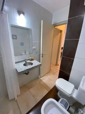 a bathroom with a toilet and a sink and a mirror at LitStay Trejo in Cordoba