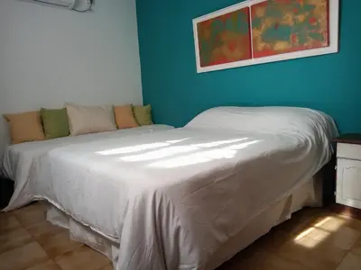 a bed in a room with a blue wall at Petunia in Cordoba