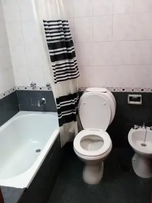 a bathroom with a toilet and a tub and a sink at Petunia in Cordoba