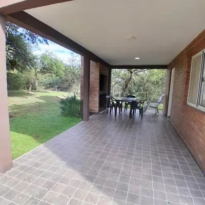 a patio with a table and chairs on it at Cabañas Amaneciendo in Merlo