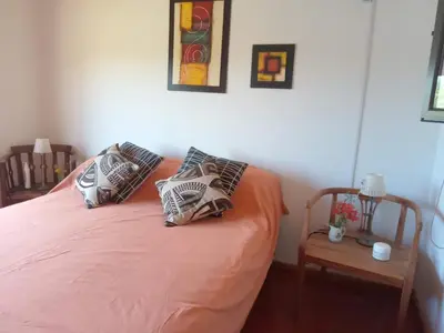 a bedroom with a bed with pillows on it at Casa Magnolia in Merlo