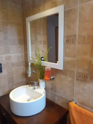 a bathroom with a white sink and a mirror at Casa Magnolia in Merlo