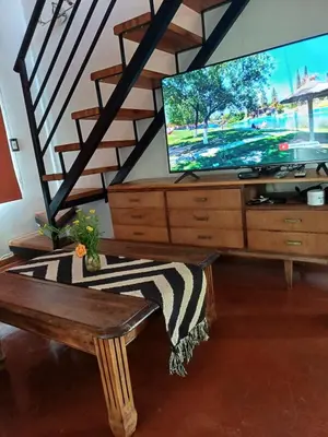a living room with a tv on a dresser at Casa Magnolia in Merlo